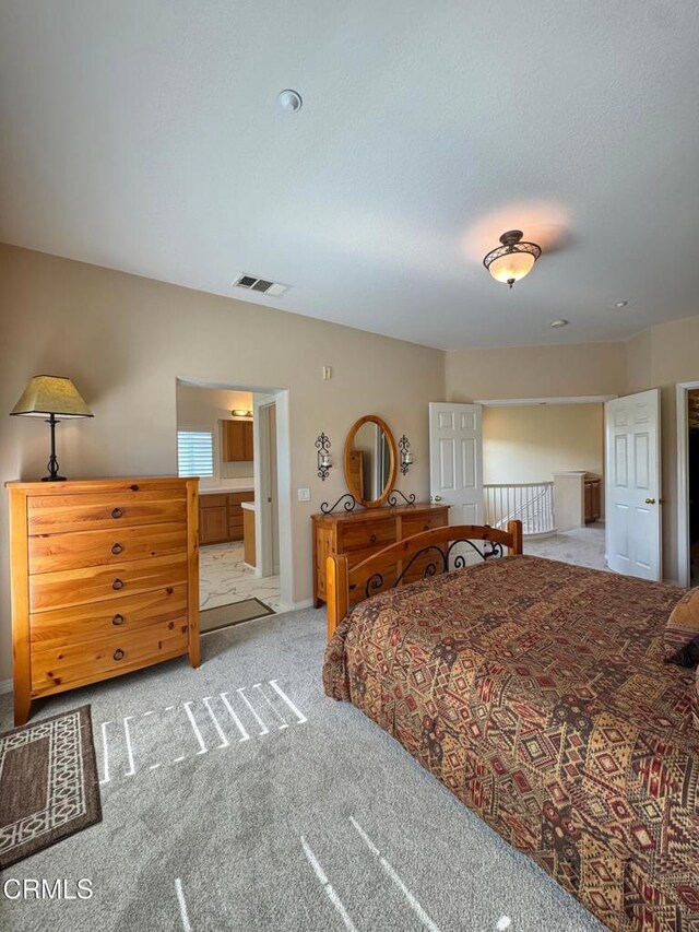 bedroom with light colored carpet