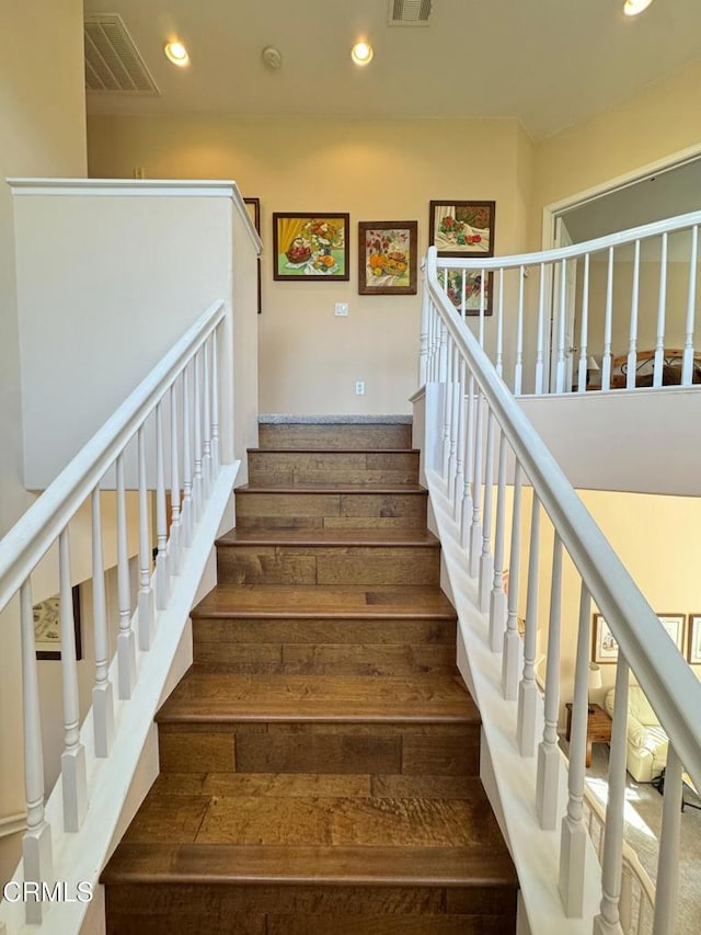 stairway with hardwood / wood-style floors