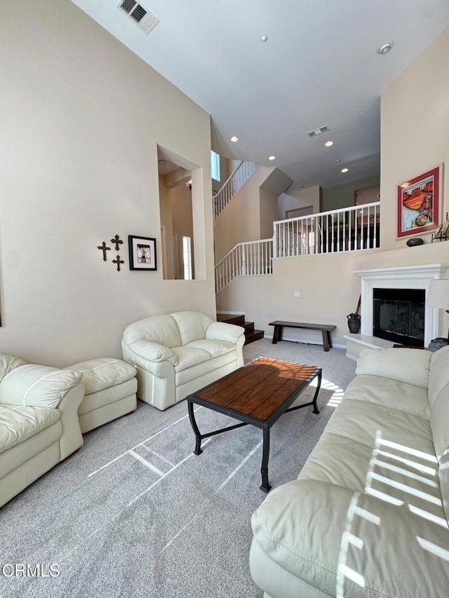 living room featuring a high ceiling and carpet