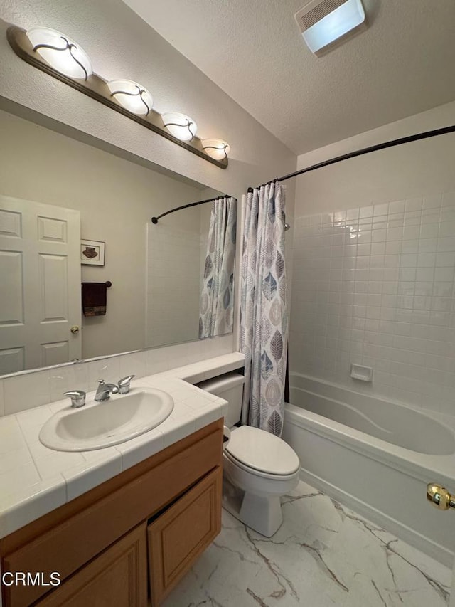 full bathroom with shower / tub combo, vanity, toilet, and a textured ceiling