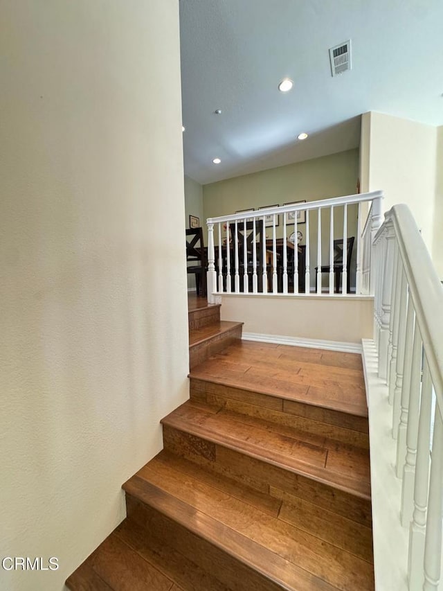 stairway with hardwood / wood-style floors