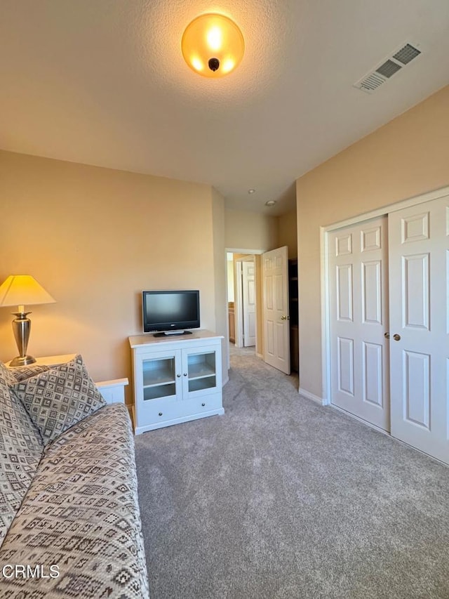 living room with carpet and a textured ceiling