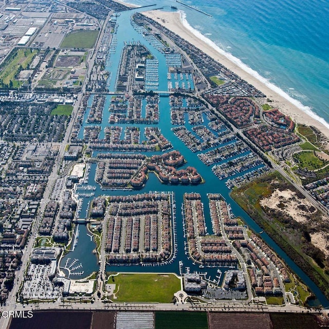 birds eye view of property featuring a water view and a beach view