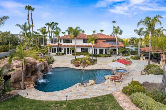 view of pool with a patio area and pool water feature