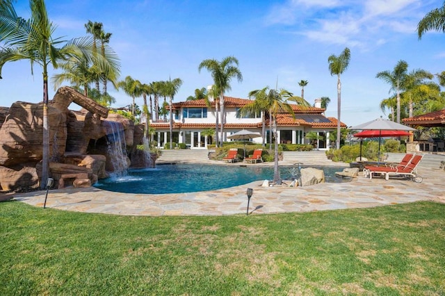 view of swimming pool with a yard, a patio area, and pool water feature