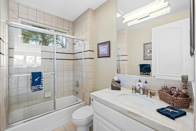 full bathroom featuring vanity, tile patterned floors, enclosed tub / shower combo, and toilet