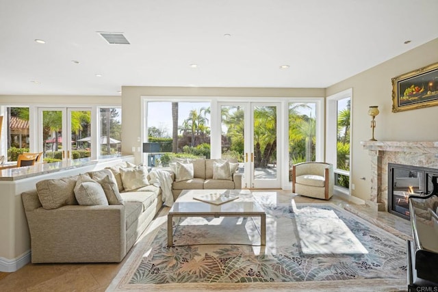 sunroom / solarium with a wealth of natural light, a fireplace, and french doors