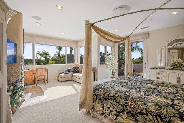 bedroom featuring multiple windows, access to exterior, and light carpet