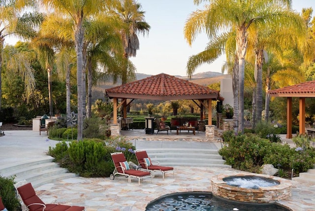 view of property's community with a gazebo, a jacuzzi, and a patio