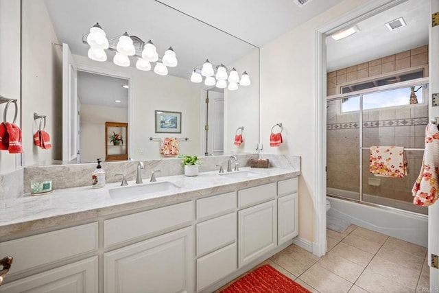 full bathroom with vanity, tile patterned floors, shower / bath combination with glass door, and toilet