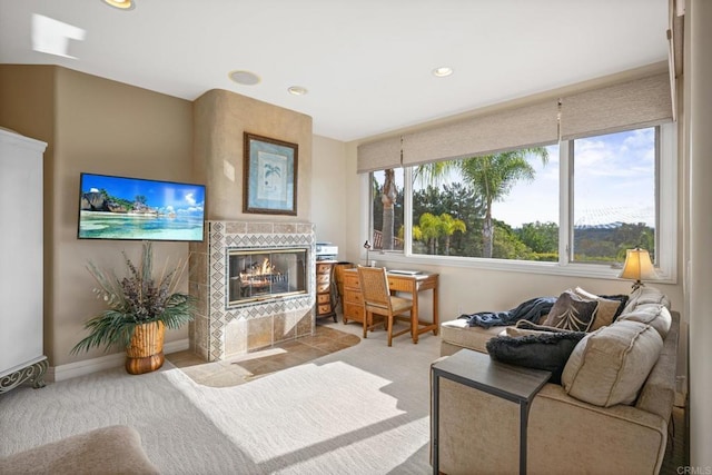 living room with light colored carpet and a tiled fireplace