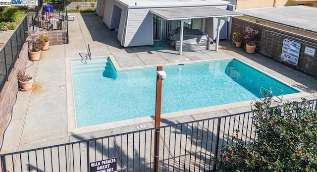 view of swimming pool featuring a patio