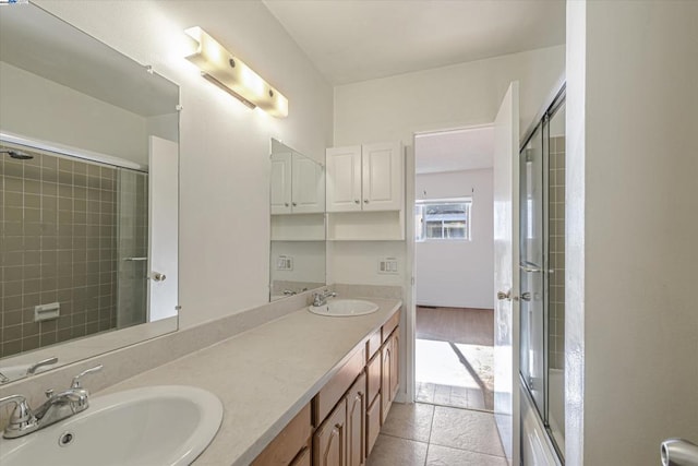 bathroom featuring vanity, a shower with door, and tile patterned floors