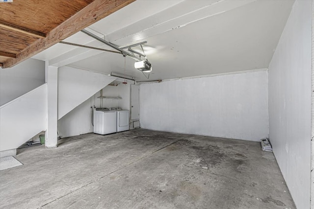 garage with a garage door opener and washer and dryer