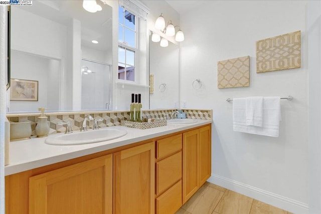 bathroom featuring vanity and a shower with shower door