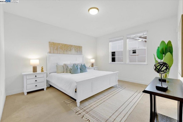 bedroom featuring light carpet