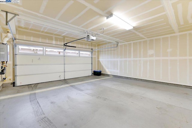 garage featuring a garage door opener and water heater