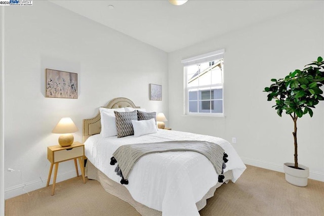 bedroom featuring lofted ceiling and carpet flooring