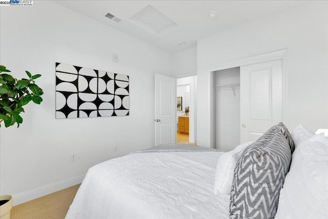 bedroom with light carpet and a closet