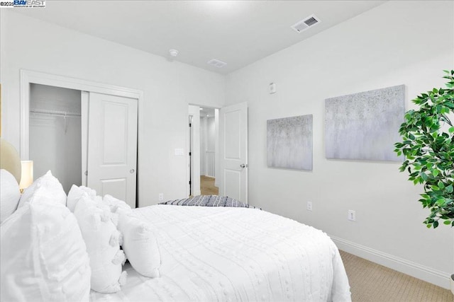 carpeted bedroom with a closet