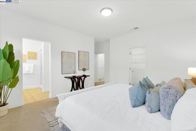 carpeted bedroom featuring a walk in closet