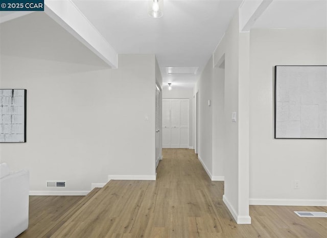 corridor with light hardwood / wood-style flooring