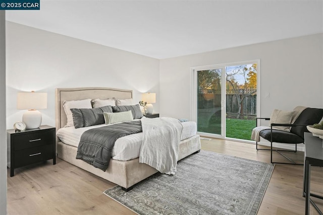 bedroom with access to exterior and light hardwood / wood-style flooring