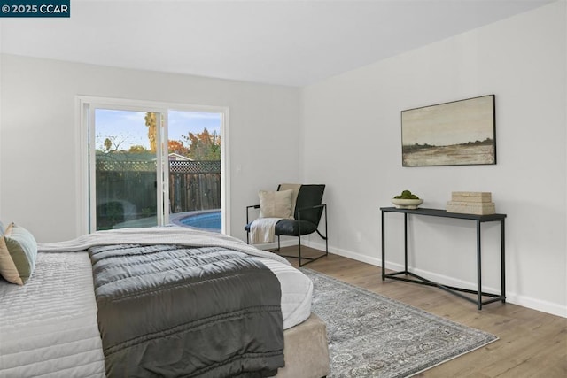 bedroom with light hardwood / wood-style flooring and access to outside