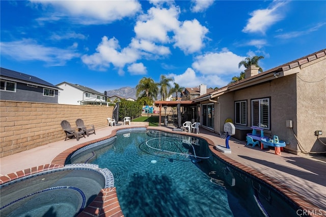 view of swimming pool with an in ground hot tub and a patio area