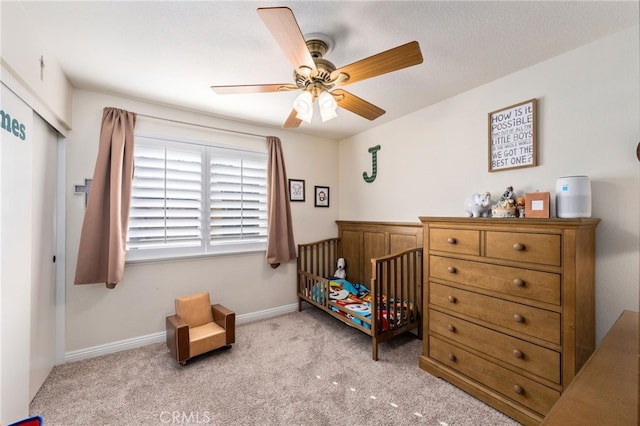 bedroom featuring light carpet, ceiling fan, and a closet