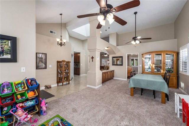 carpeted bedroom featuring decorative columns, a chandelier, and high vaulted ceiling