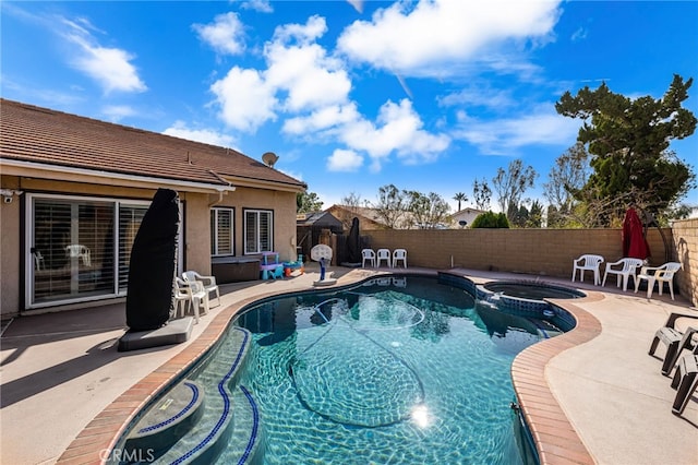 view of swimming pool featuring an in ground hot tub and a patio