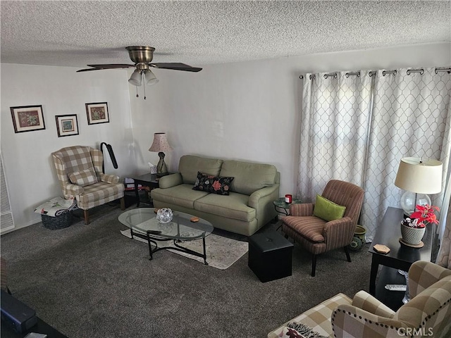 carpeted living room featuring ceiling fan and a textured ceiling