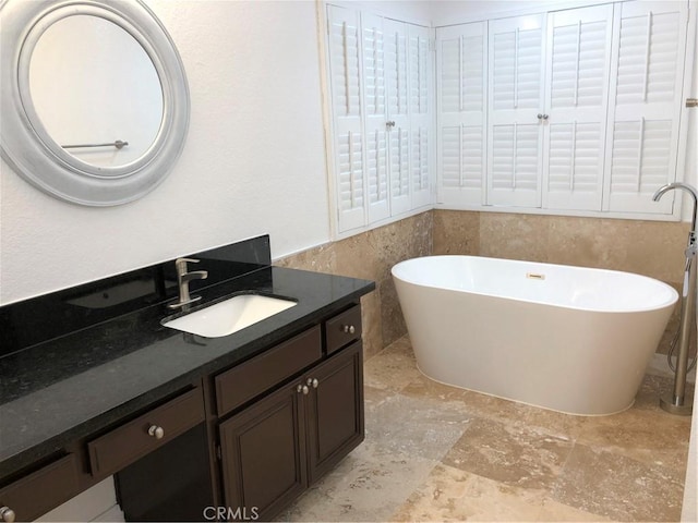 bathroom featuring vanity and a bathing tub