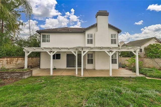 back of house featuring a yard, a pergola, and a patio