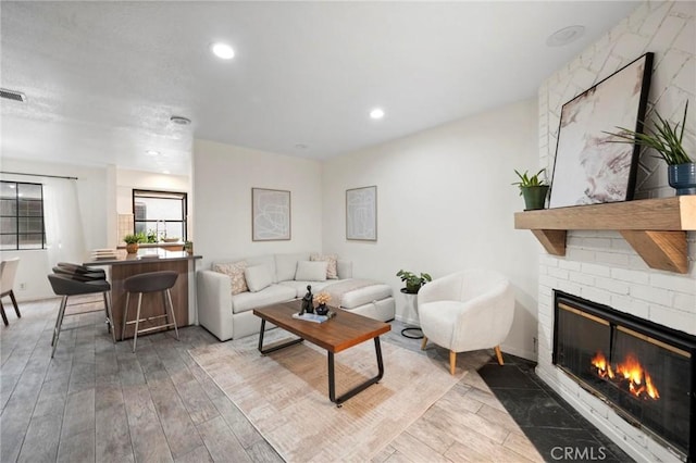 living room featuring hardwood / wood-style flooring and a fireplace