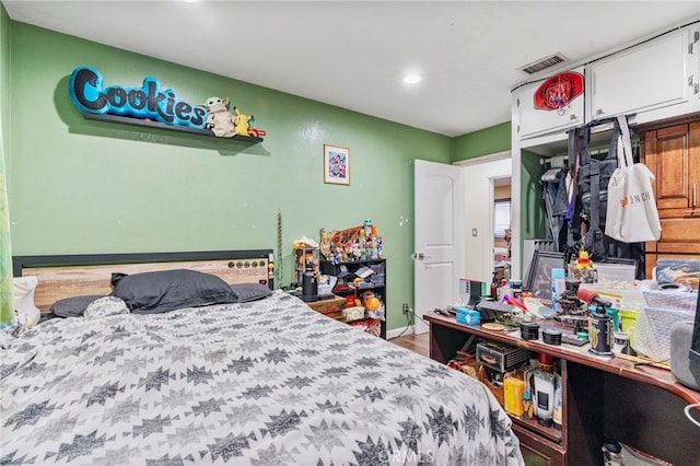 bedroom with hardwood / wood-style floors