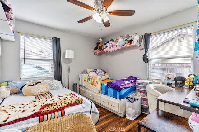 bedroom with ceiling fan and dark hardwood / wood-style flooring