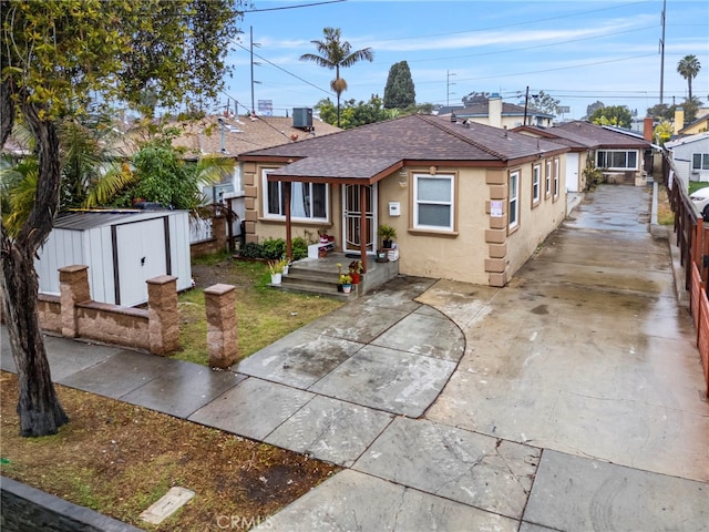 bungalow with a shed and central air condition unit