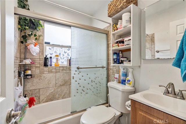 full bathroom with vanity, shower / bath combination with glass door, and toilet