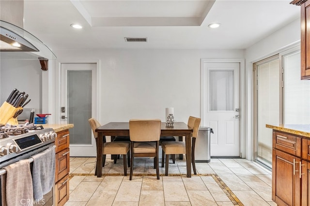 dining area with a raised ceiling