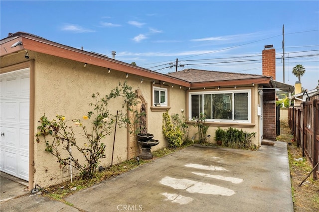 back of property featuring a garage