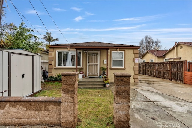 view of front of home with a storage shed