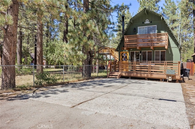 rear view of property featuring a wooden deck