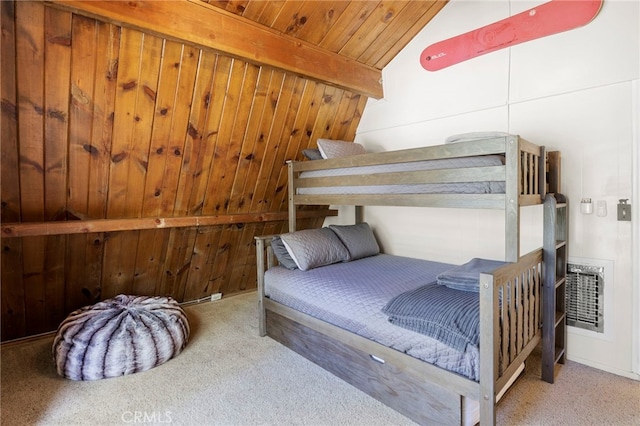 bedroom with carpet floors, wooden walls, lofted ceiling with beams, and wooden ceiling