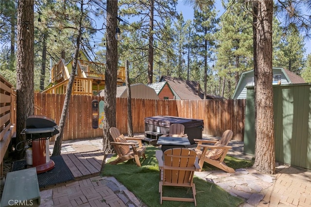 view of patio / terrace with a hot tub, a wooden deck, and area for grilling