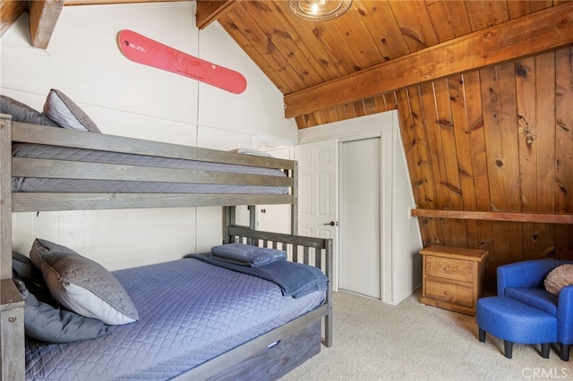 bedroom with wood ceiling, lofted ceiling with beams, light colored carpet, and wooden walls