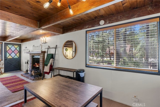 interior space with wood ceiling, a fireplace, and beamed ceiling