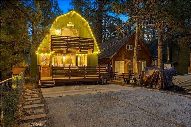 view of front of house with a deck and a storage unit