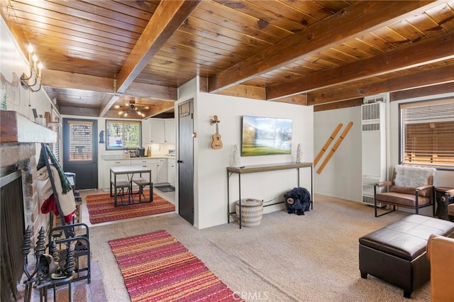 living room featuring beamed ceiling, light colored carpet, wood ceiling, and a stone fireplace